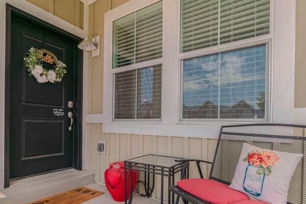 Porch with front door and seating area